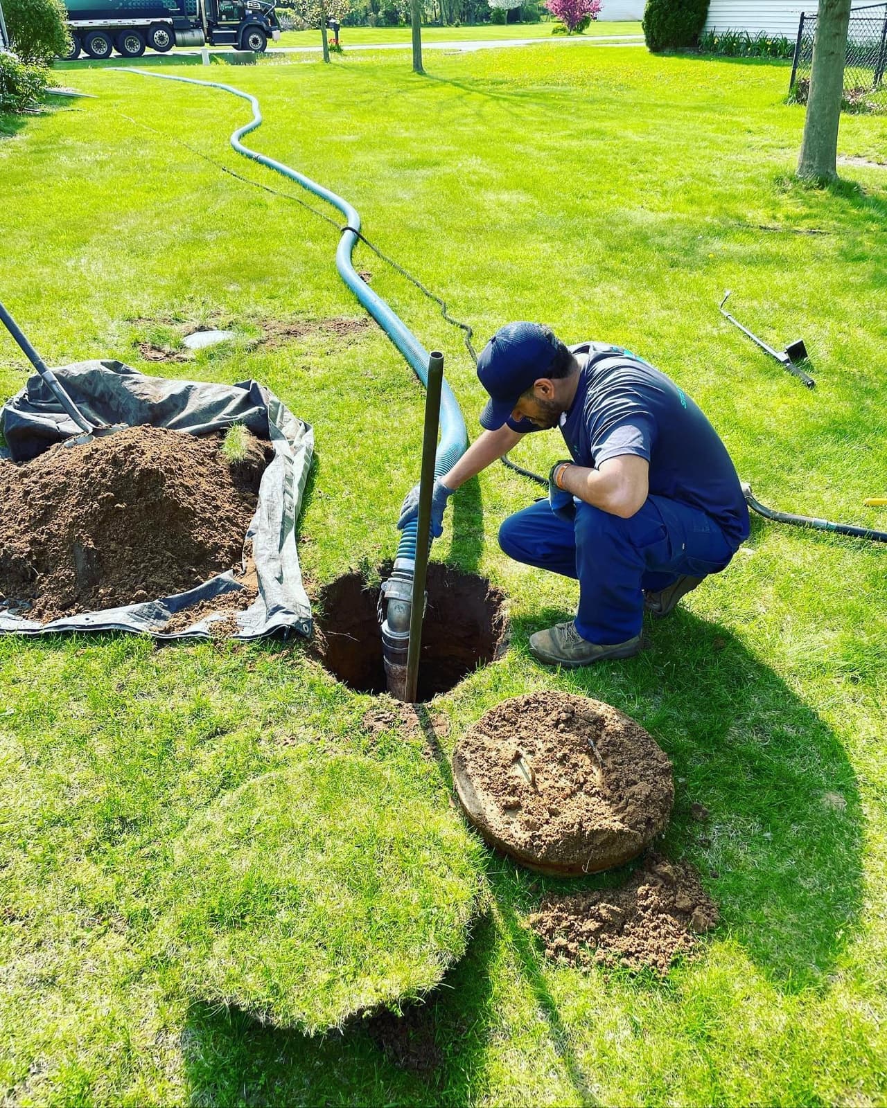 Smart Septic technician pumping a residential septic tank