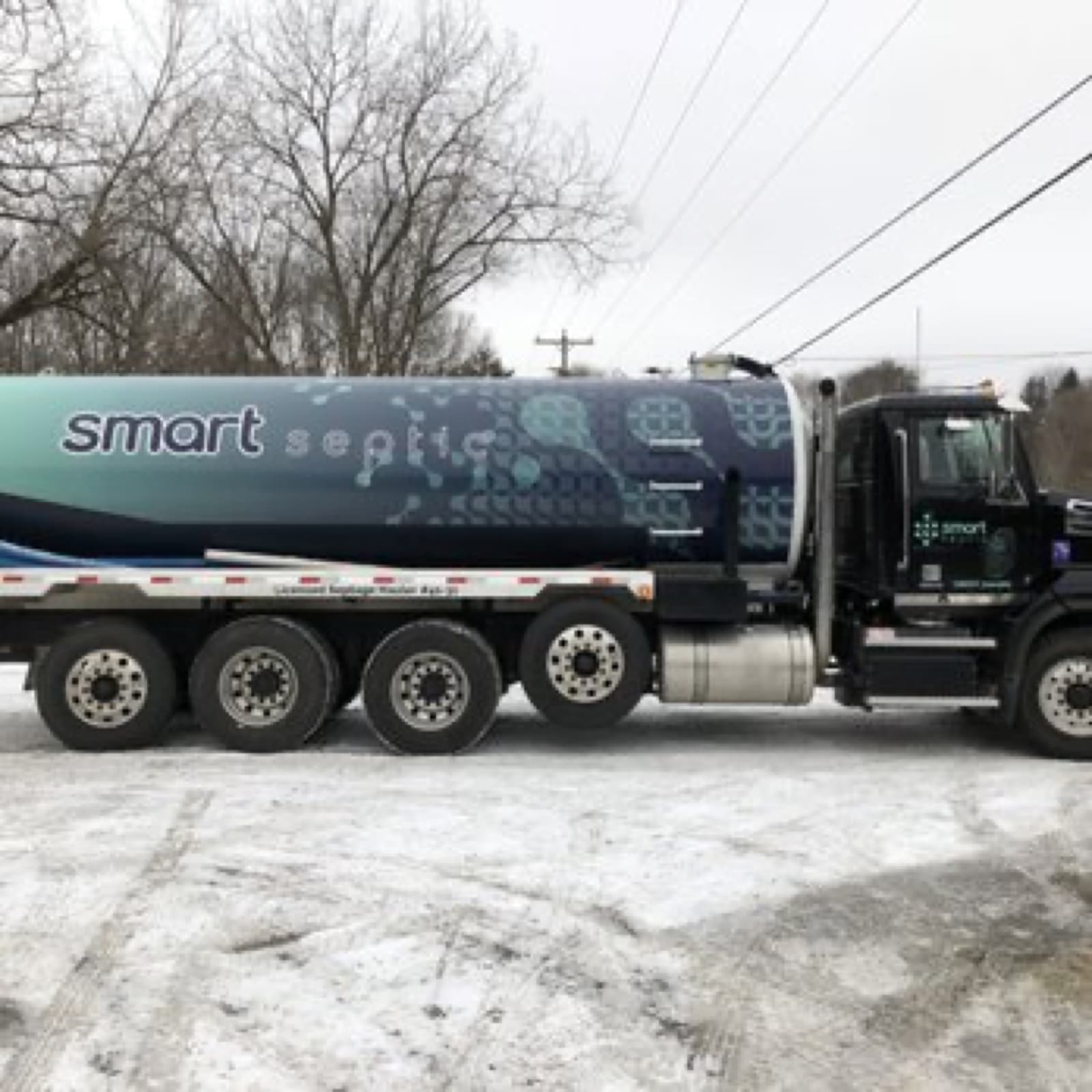 Side view of the branded Smart Septic tanker truck